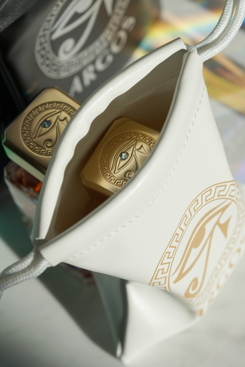 Argos Genuine Leather Bag white with gold name design having a perfume bottle inside.