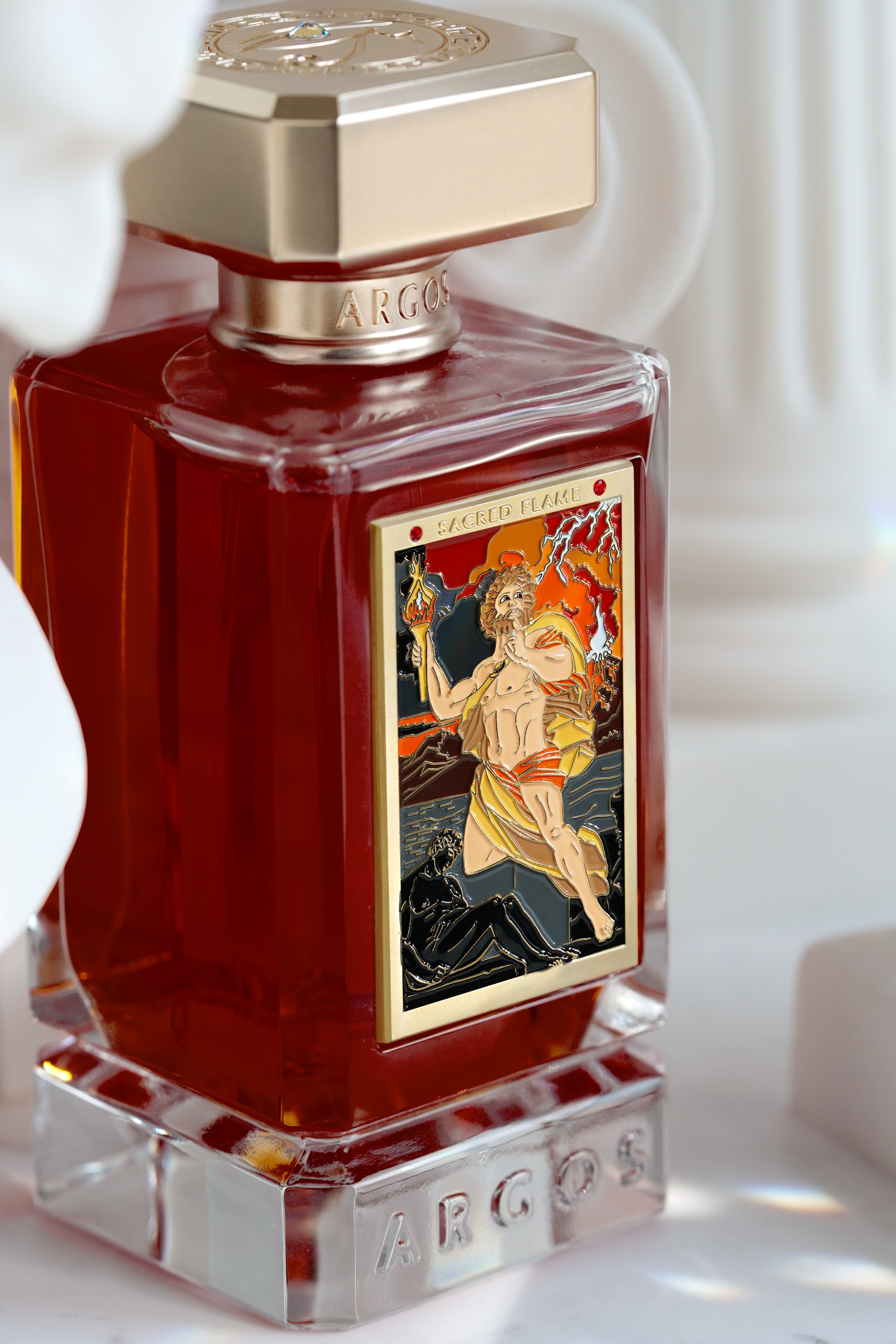 Argos Sacred Flame perfume displayed on a roman greek background with enhanced lighting.

