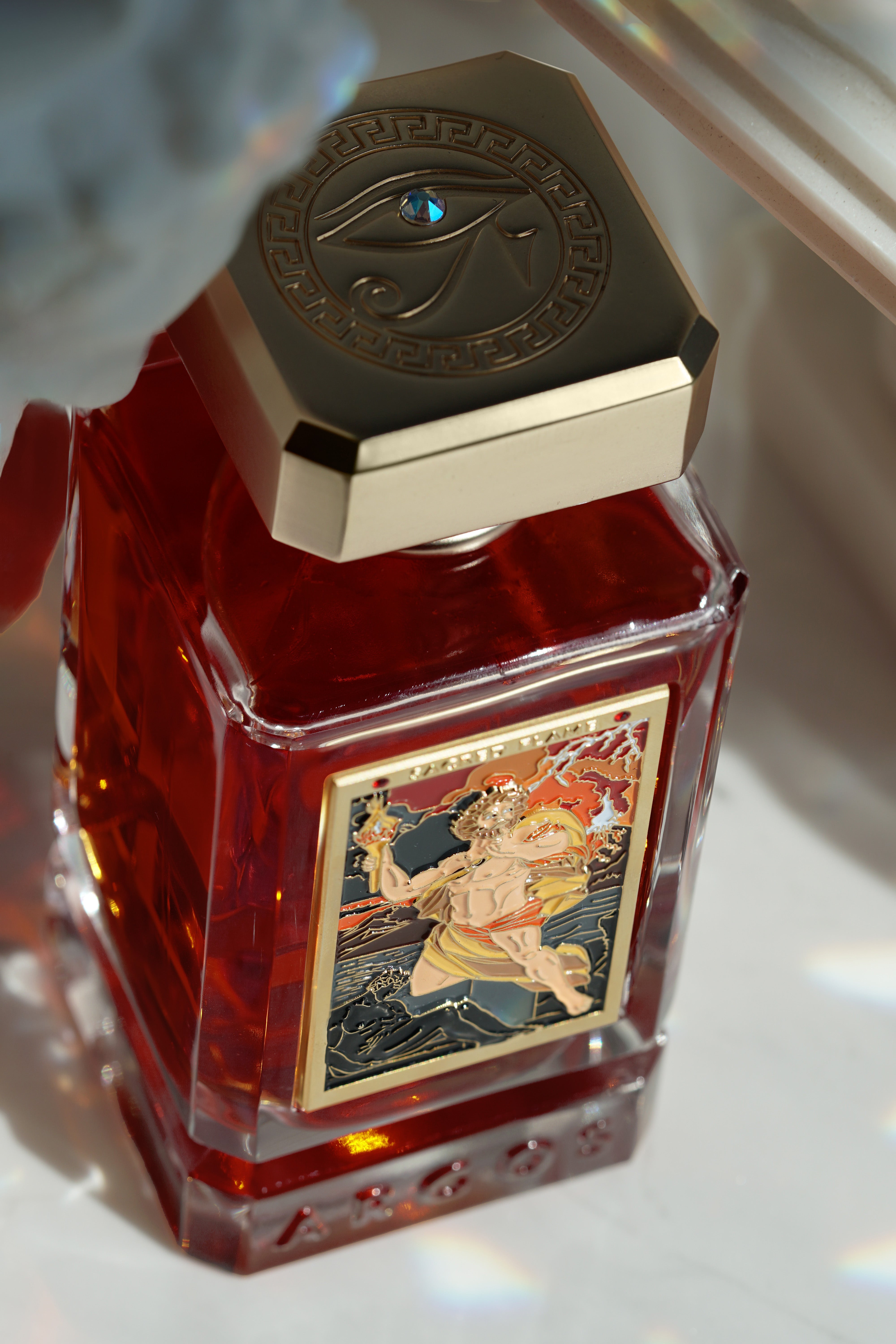 Flatlay shot of Sacred Flame perfume with a luxury-themed background.