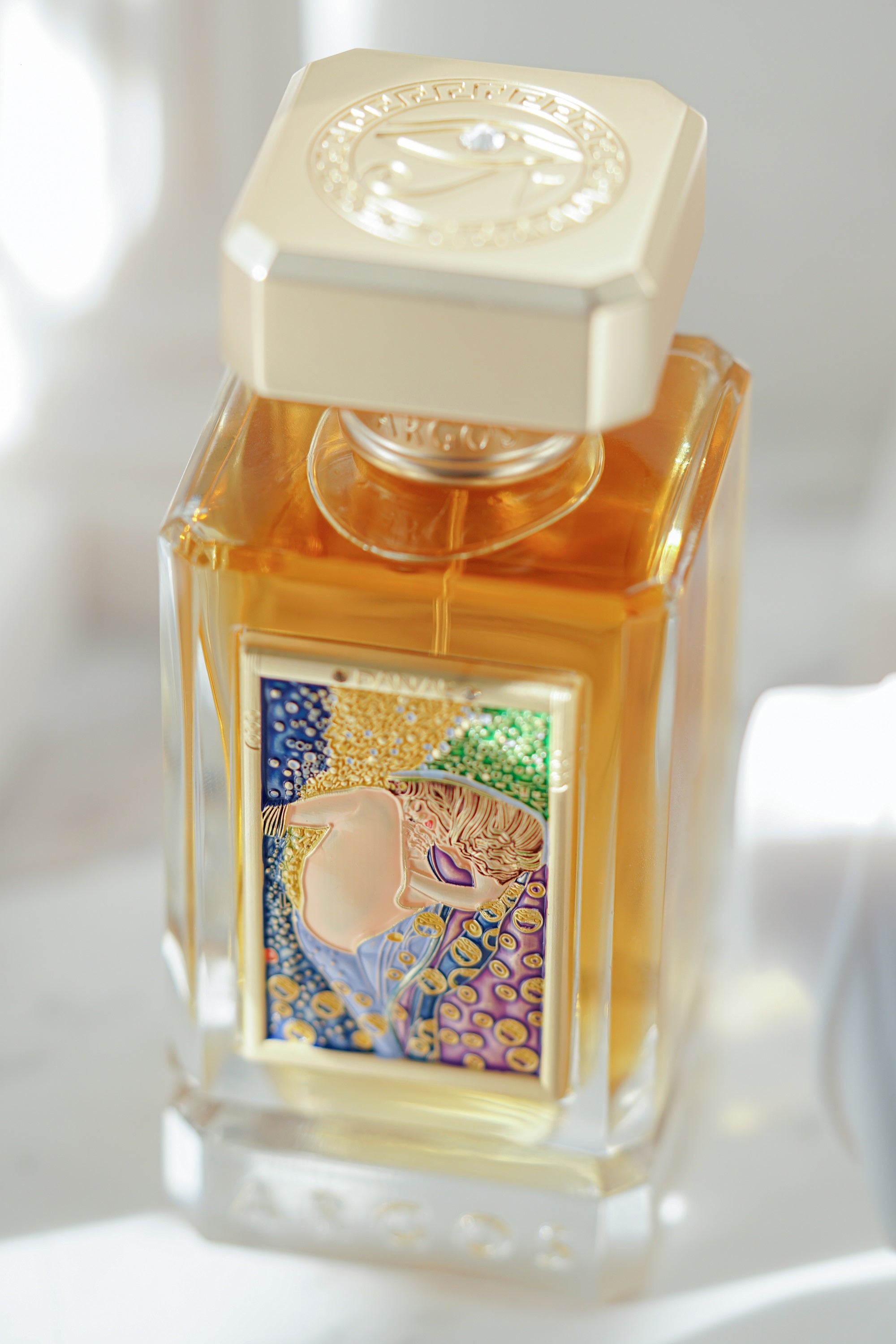 New Argos DANAE Perfume 100ml Bottle Little Right Facing Captured Naturally and Surrounded with Sculptures